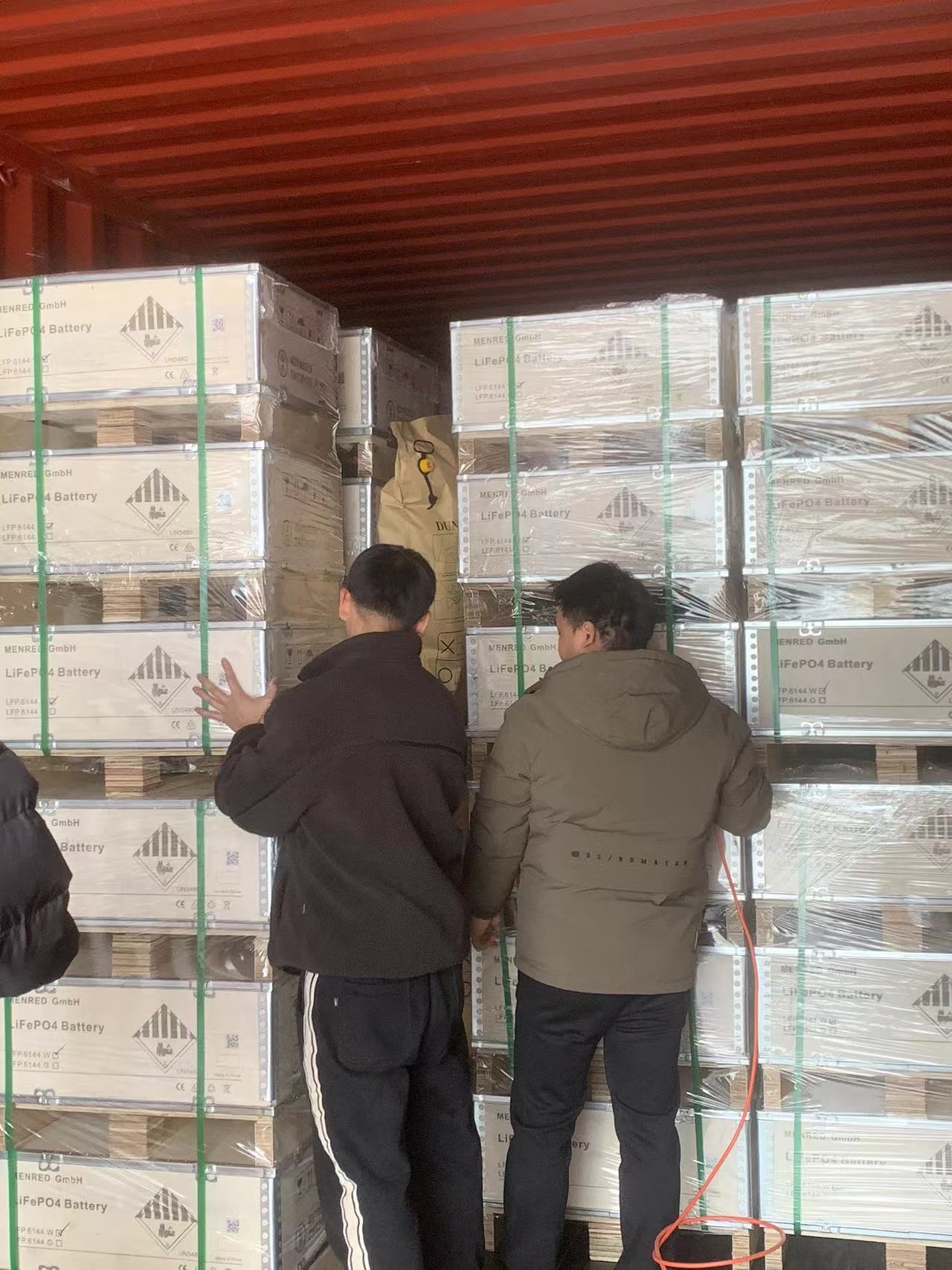 MENRED ESS team loading Solutions Solar Battery into container for shipment